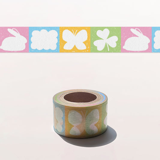 Roll of decorative tape with colorful designs on a white background