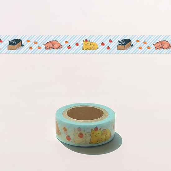 Roll of decorative tape with cat designs on a light pink background