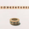 Roll of decorative tape with acorn pattern on a light background