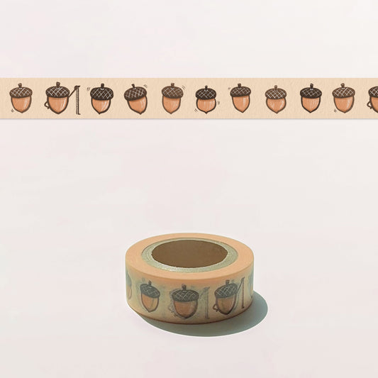Roll of decorative tape with acorn pattern on a light background