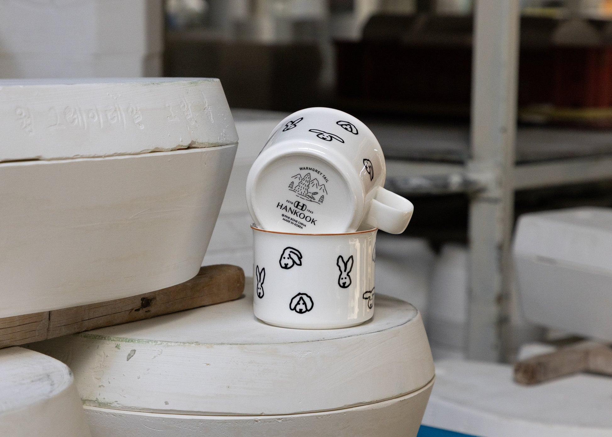 Set of ceramic mugs with rabbit design on a white surface