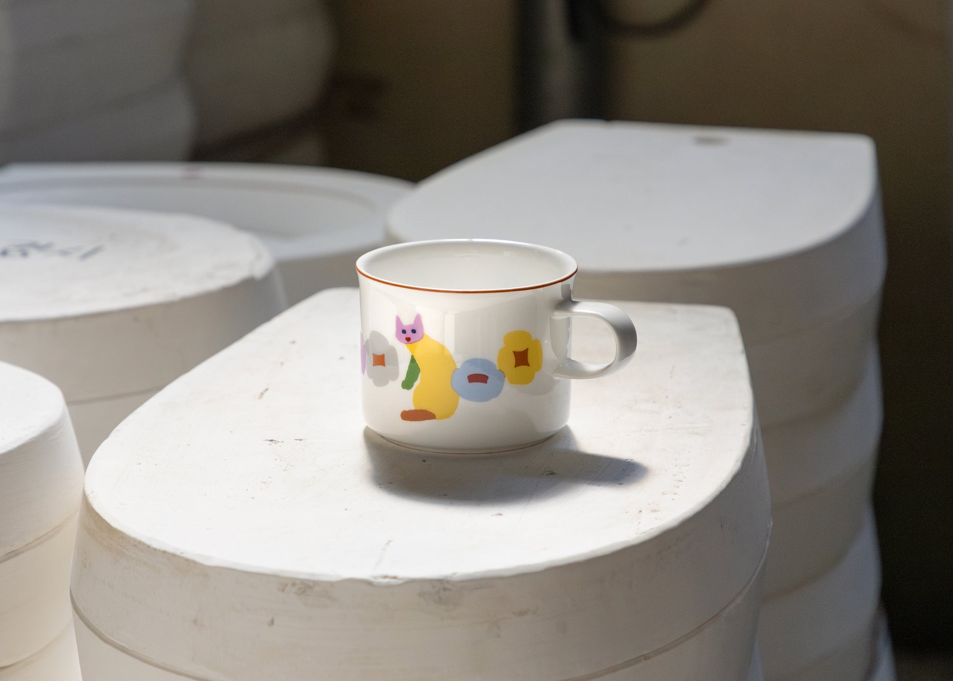Ceramic mug with colorful design on a white surface