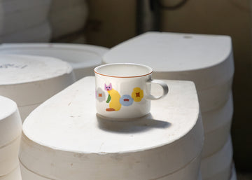 Ceramic mug with colorful design on a white surface