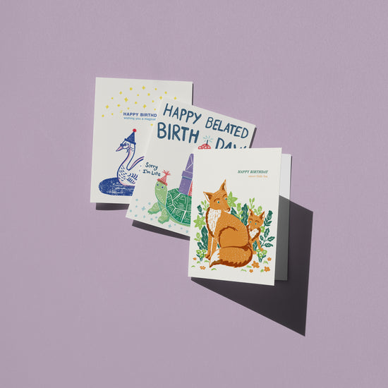 greeting cards with animal illustrations on a purple background