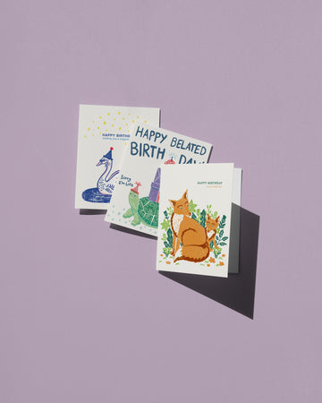 Three birthday cards with animal illustrations on a purple background
