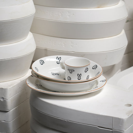 White ceramic dishes with black patterns on a white background