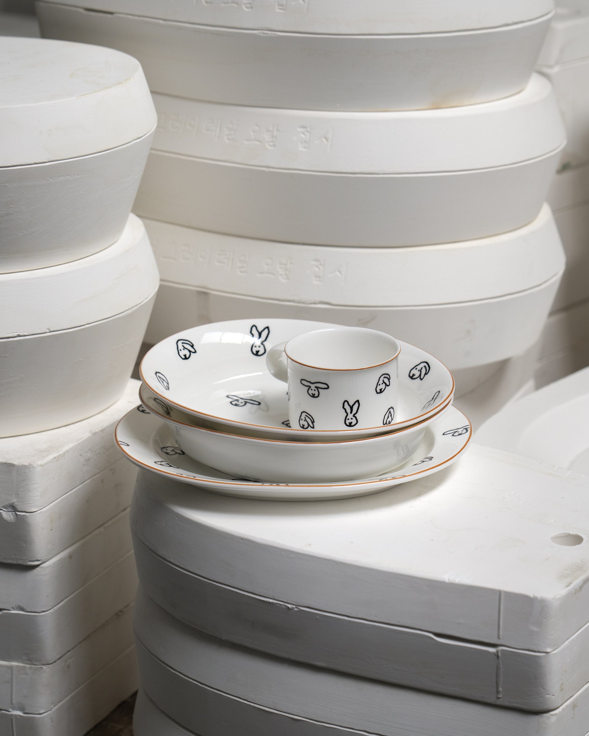 White ceramic dishes with black patterns on a white background