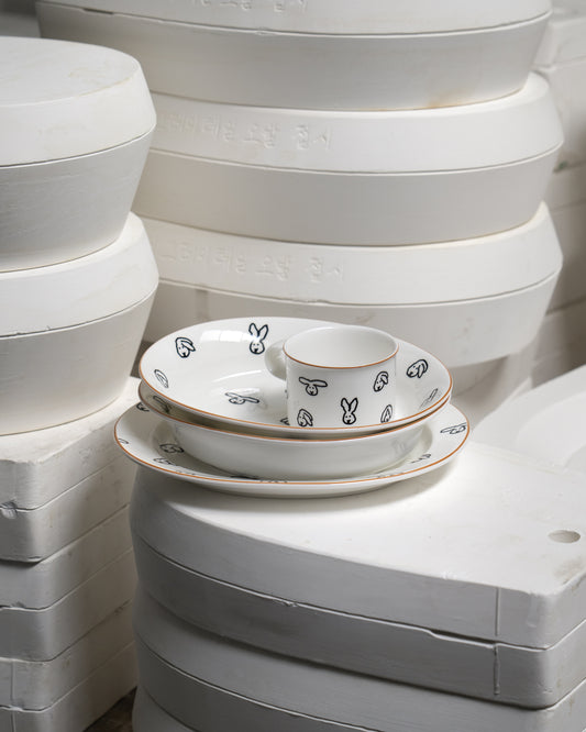 White ceramic dishes with black patterns on a white background