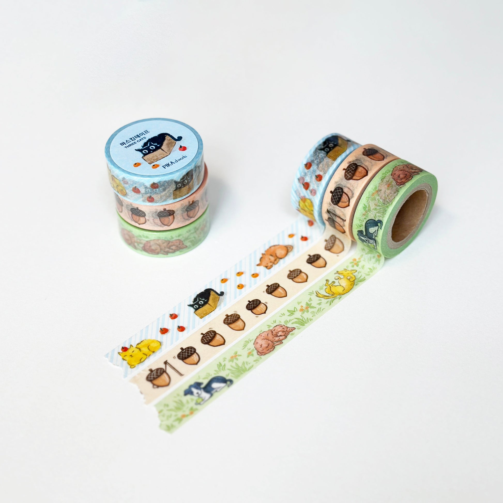 Three rolls of decorative tape with animal and acorn illustrations on a white background