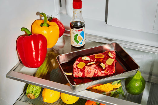 Frozen meat tray with vegetables on a refrigerator shelf