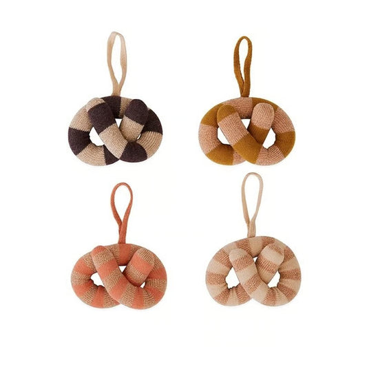 Four woven knot ornaments in different colors on a white background