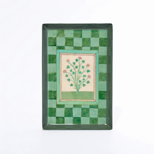 A rectangular decorative tray with a green checkerboard border and a central floral illustration on a cream background, shown against a plain white backdrop.