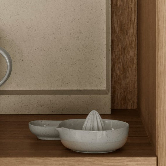 Wooden kitchen shelves with ceramic dishes and glasses.