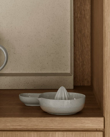Wooden kitchen shelves with ceramic dishes and glasses.