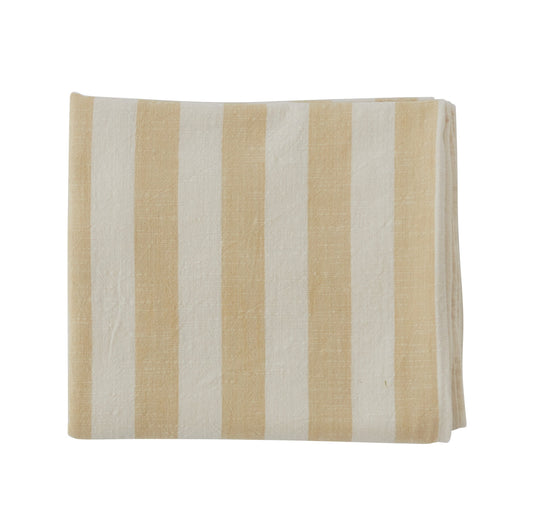 Light-yellow and white striped rectangular tablecloth laid flat, with the fabric’s linen-like texture visible