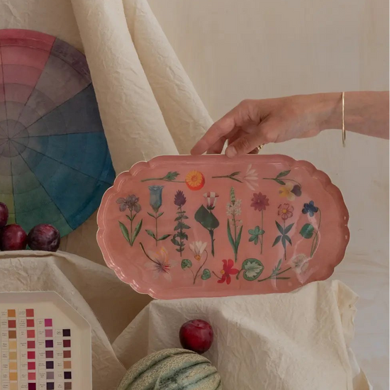Decorative platters with floral design and color swatches on a neutral background