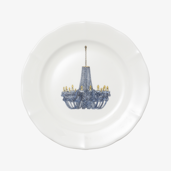 White plate with a decorative blue chandelier design on a white background