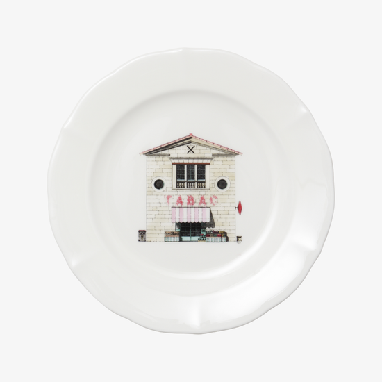 White plate with a printed design of a building on a white background