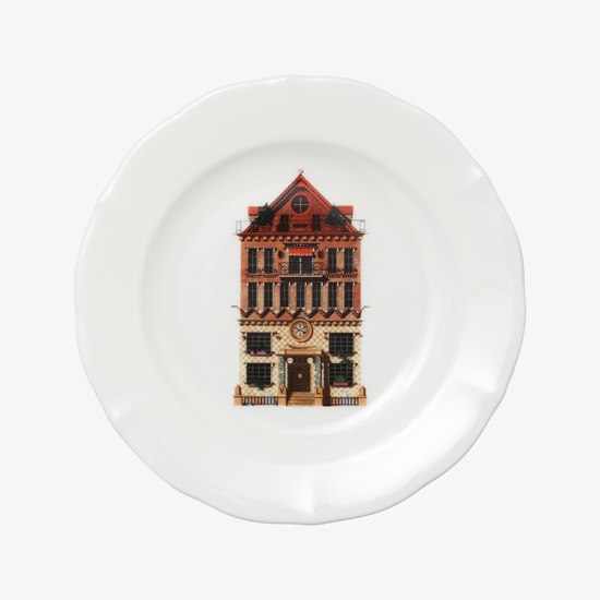 White plate with a decorative design of a building on a white background