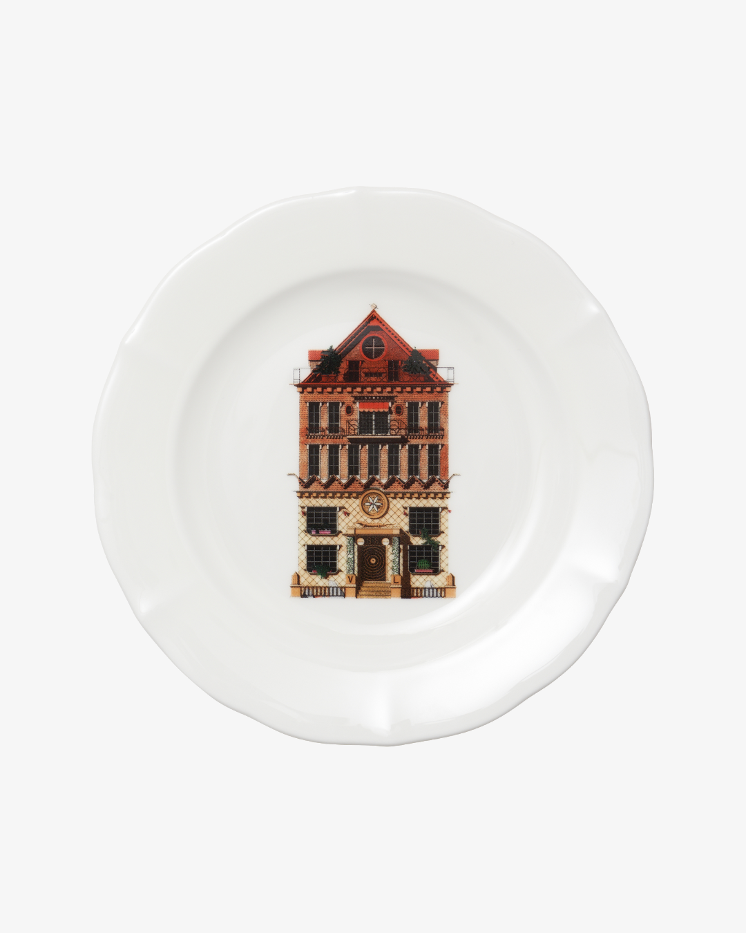 White plate with a decorative design of a building on a white background