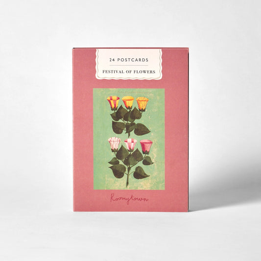 A boxed card set titled '24 POSTCARDS FESTIVAL OF FLOWERS' with a dusty pink cover, a central floral illustration on a pale green panel, photographed on a light gray background.