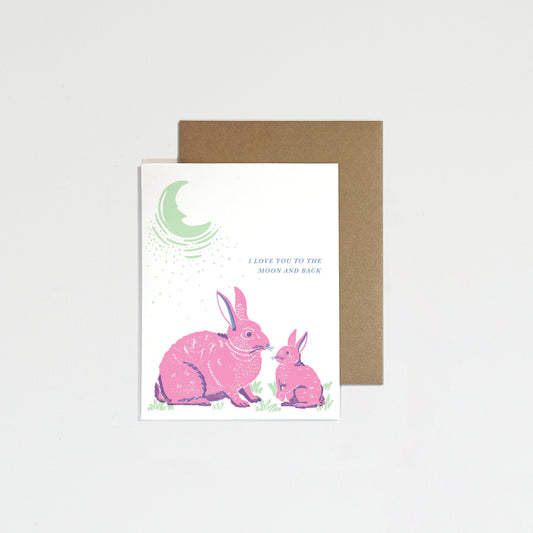 Greeting card with pink bunnies and moon on a light gray background
