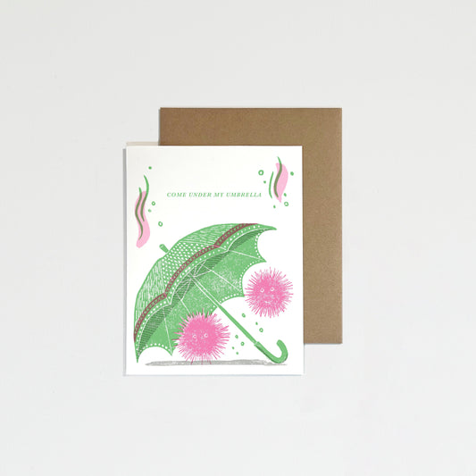 Greeting card with green umbrella on a white background