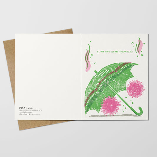 Greeting card with green umbrella on a white background