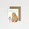 Greeting card with a bear illustration and lamp on a white background.