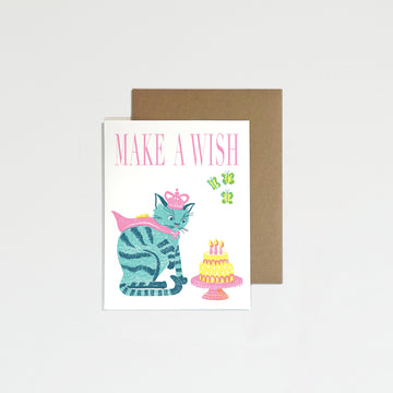 Greeting card with a cat and cake illustration and 'Make a Wish' text, on a white background.