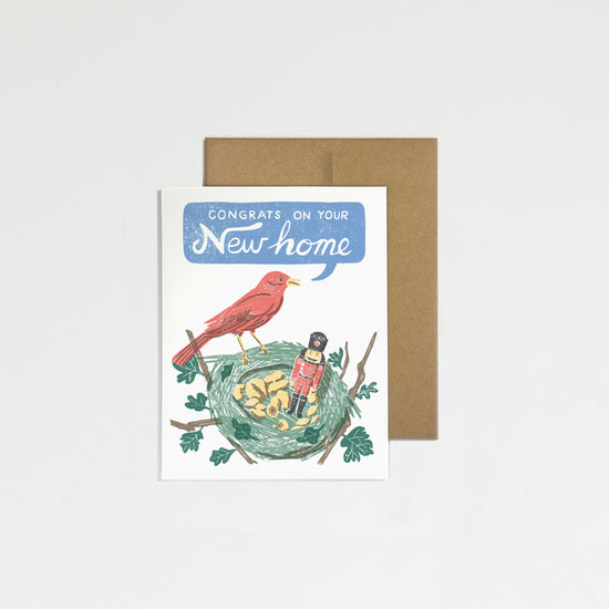 Greeting card with illustration of birds and text 'Congratulations on your new home' on a plain background