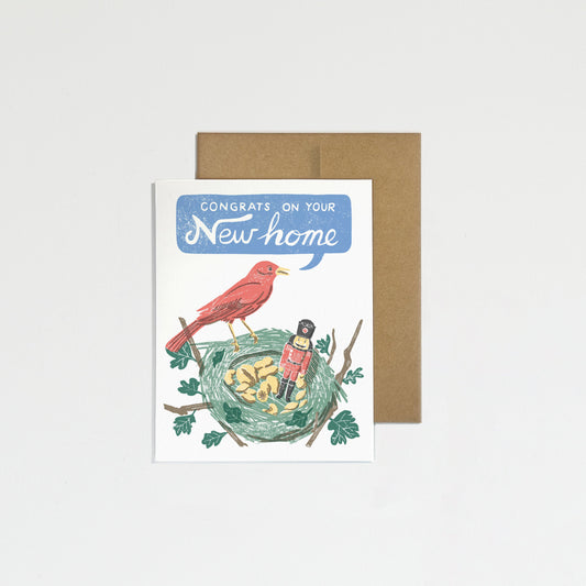 Greeting card with illustration of birds and text 'Congratulations on your new home' on a plain background