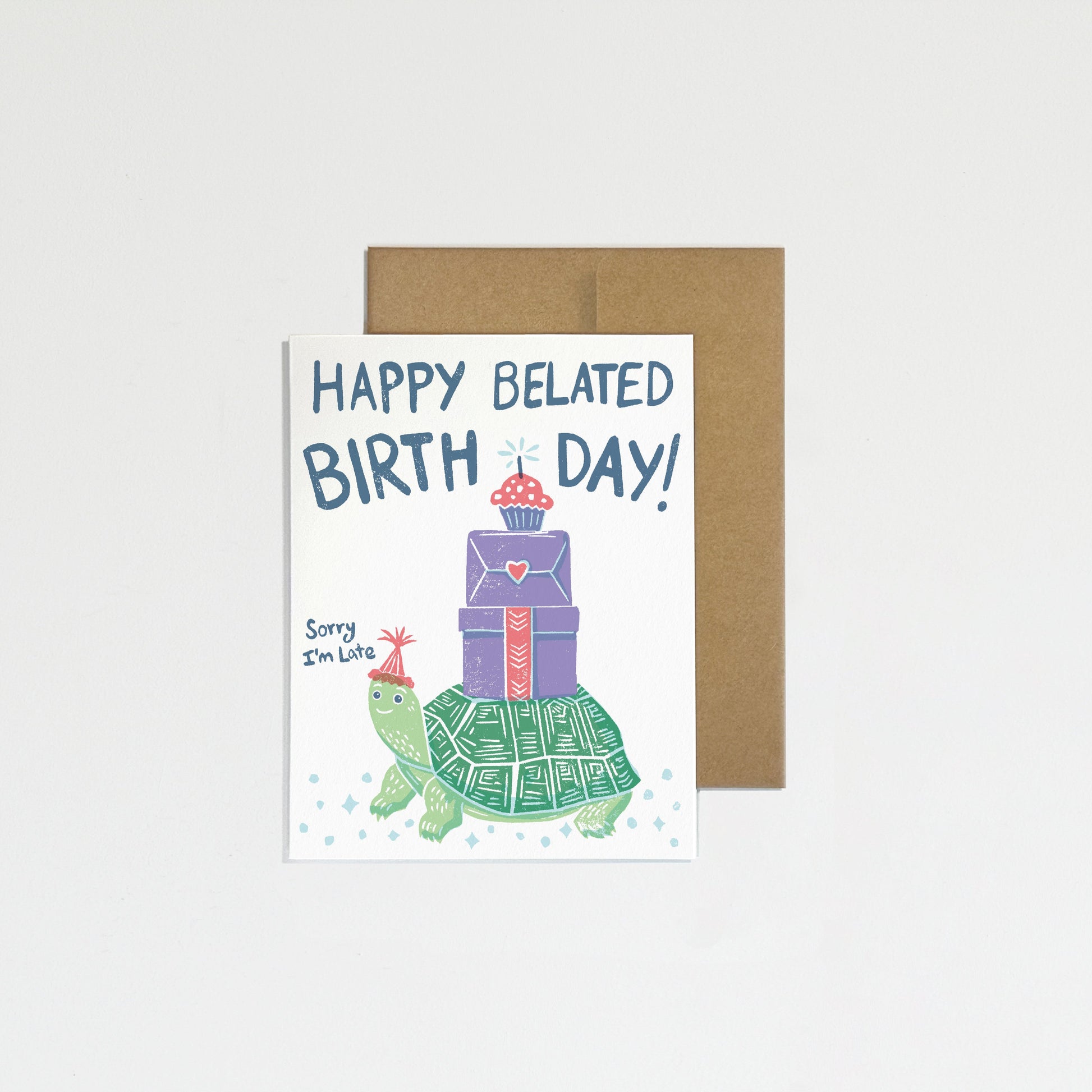 Greeting card with turtle and gift illustration and 'Happy Belated Birthday!' text on a white background
