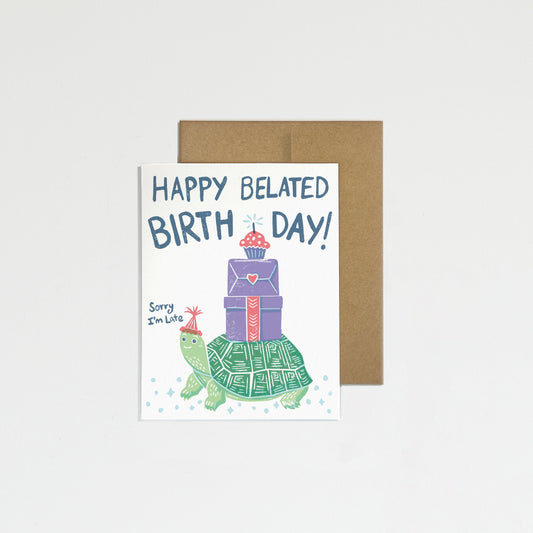 Greeting card with turtle and gift illustration and 'Happy Belated Birthday!' text on a white background