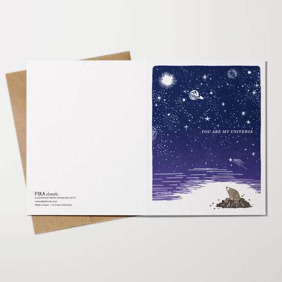Greeting card with space-themed design on a white background