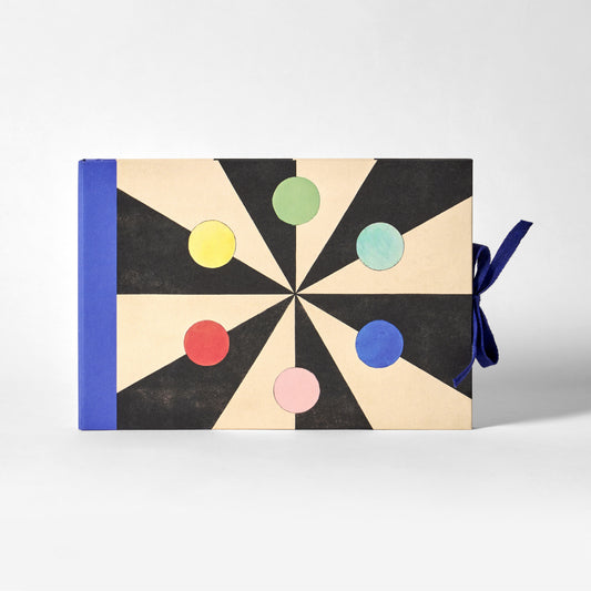 Book with a geometric design featuring colorful circles on a black background