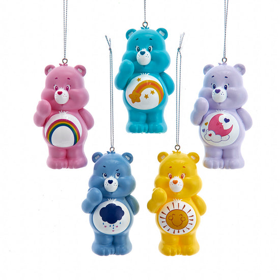 Five colorful Care Bear ornaments on a white background