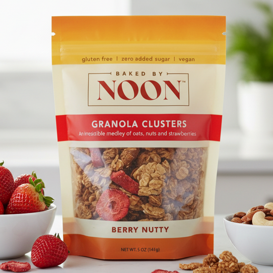 Packaging of Baked by Noon granola clusters with a berry nutty flavor on a white background.