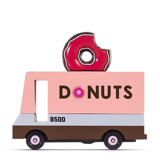 Pink wooden toy donut truck with a bite-mark donut decoration on top and the word ‘DONUTS’ printed on the side