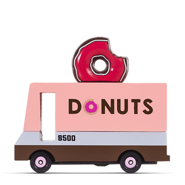 Pink wooden toy donut truck with a bite-mark donut decoration on top and the word ‘DONUTS’ printed on the side