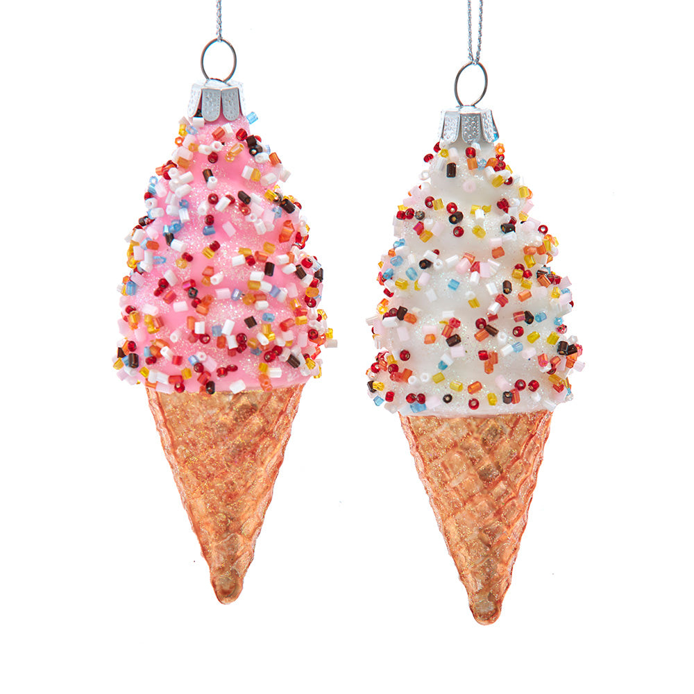 Two ice cream cone ornaments with sprinkles on a white background