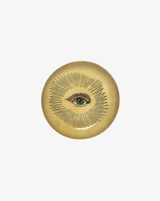 Decorative plate with eye design on a white background