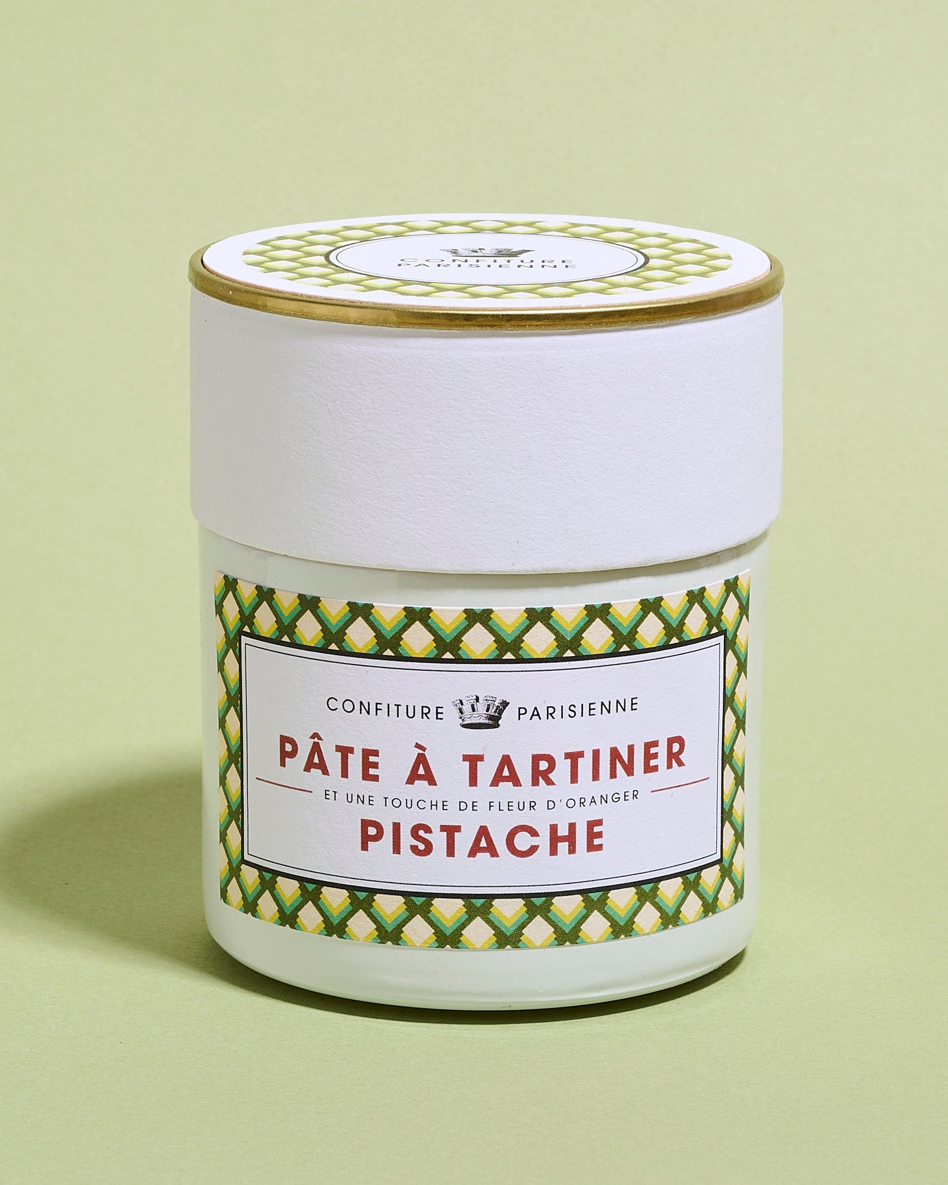 Jar of Pate a Tartiner Pistache on a light green background