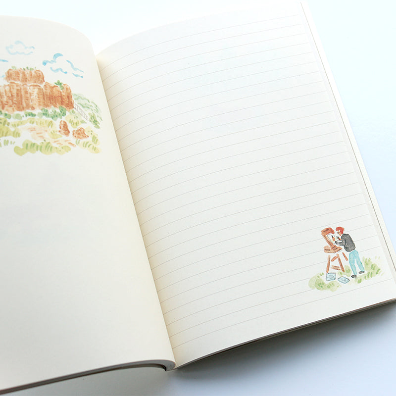 Open notebook with a decorative sticker of two people on a blue background