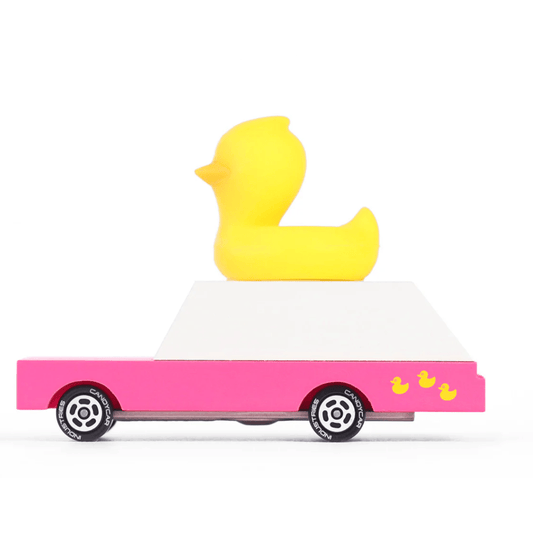 Pink wooden toy car with a large yellow rubber duck on top and small duck decals near the rear wheel.