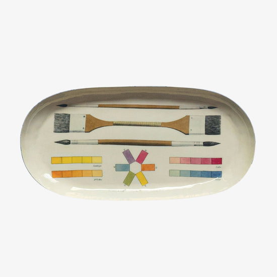 Set of paintbrushes and color swatches on a white background