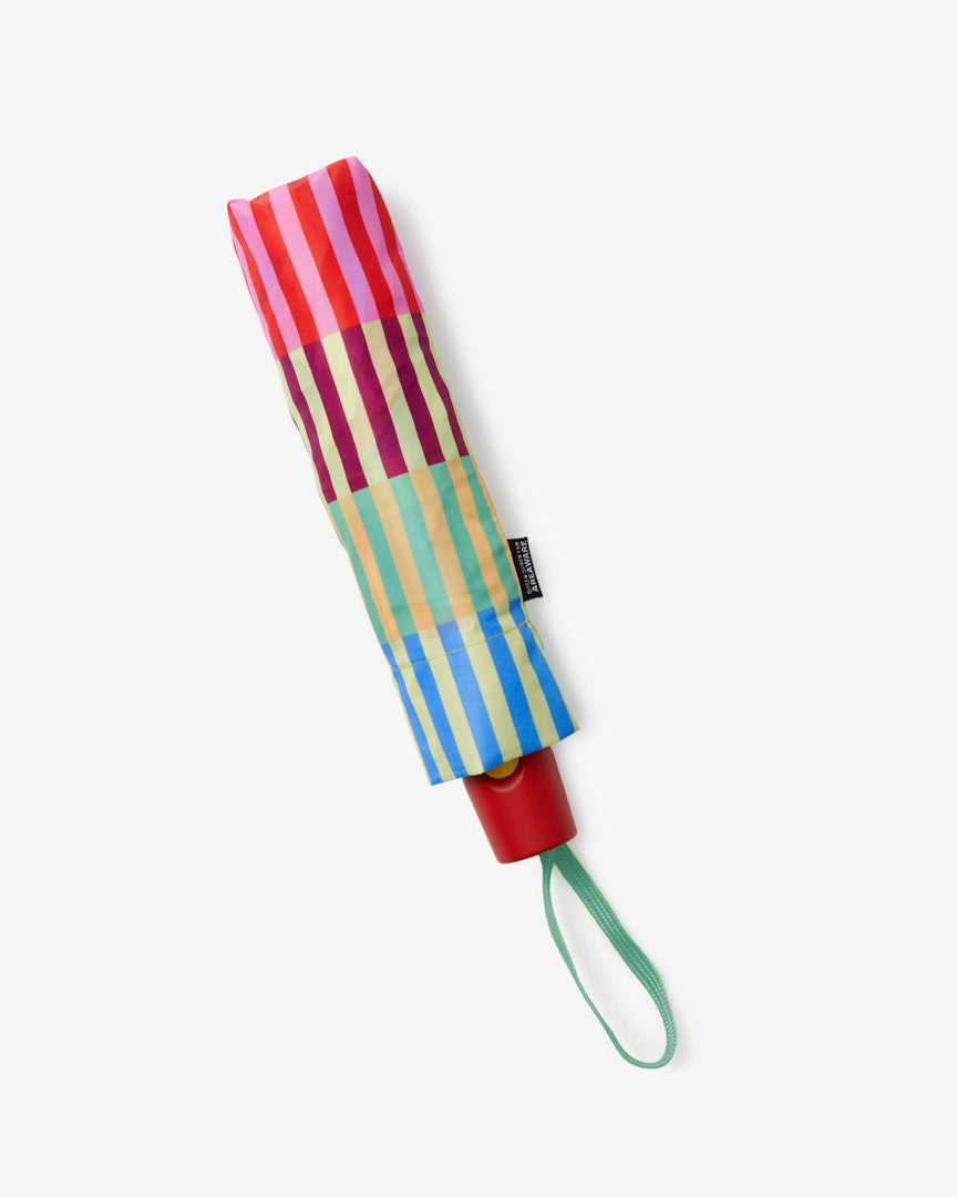 Colorful striped umbrella with a red handle on a white background
