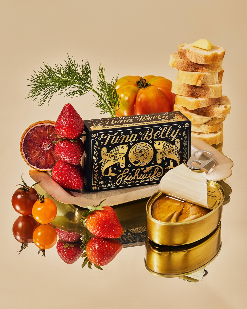 Tuna belly packaging with fruits, bread, and a can on a beige background