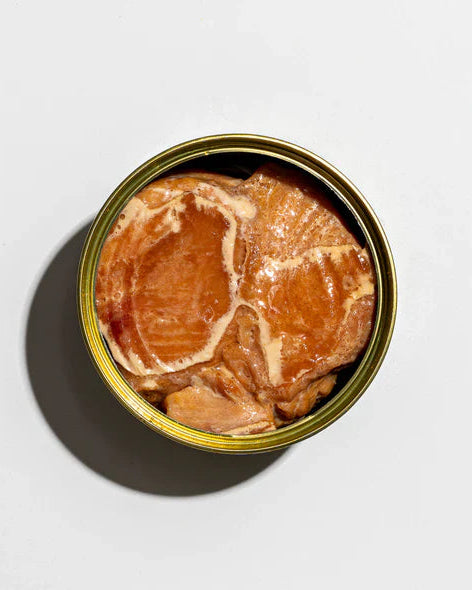 Opened smoked albacore tuna on a white background