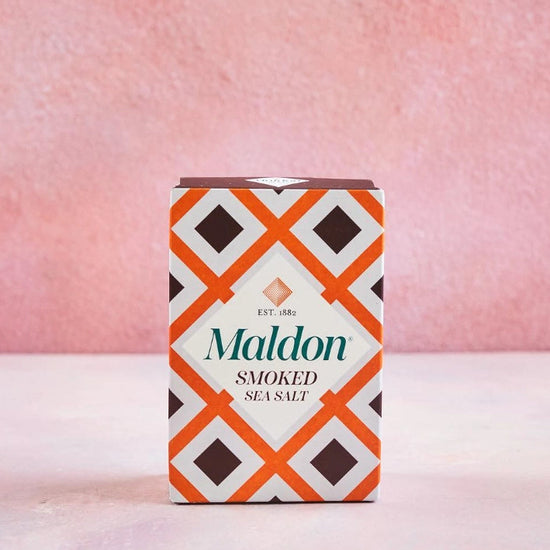 Maldon smoked sea salt packaging with a geometric pattern on a pink background